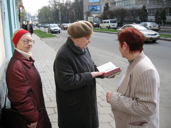 An image of Jehovah's Witnesses preaching door-to-door (option 2)