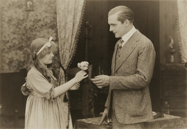 File:OldHeidelberg 1915 GirlGivingFlower.jpg