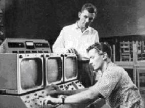 thumb Dewey Gentry (L) observes Henry J. Cauthen (R), technical director, switching equipment of the closed-circuit ETV Experiment in 1958 at Dreher