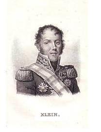 Klein has light curly hair and a round face; he wears heavy epaulets on the shoulders of an ornately embroidered jacket, decorated with military medals.