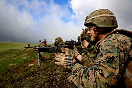 A soldier with the 17th Vânători de munte Battalion fires an M240B machine gun with a U.S. Marine with Black Sea Rotational Force, during a live-fire exercise in the Carpathian Mountains, 2014