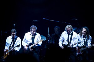 The Eagles in 2008 during their Long Road Out of Eden Tour (left to right): Glenn Frey, Don Henley, Joe Walsh, Timothy B. Schmit (behind them is touring drummer Scott F. Crago)