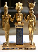 Osiris on a lapis lazuli pillar in the middle, flanked by Horus on the left, and Isis on the right; 875–850 BC; gold and lapis lazuli; 9 cm (3.5 in); Louvre