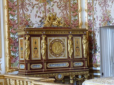 Louis XVI style caryatids with Ionic capitals on their heads, on a jewelry locket of Marie-Antoinette, by Ferdinand Schwerdfeger, 1787, mahogany, mother-of-pearl inlays, paintings under glass, porcelain plate, and gilded bronzes, Chambre de la Reine, Palace of Versailles, Versailles, France[27]