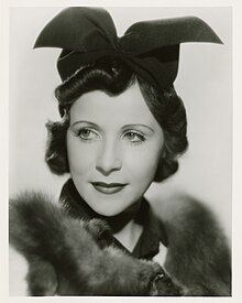 Headshot of Irene Saltern wearing a black hat and a fur stole