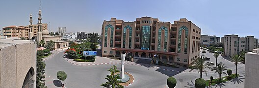 A panoramic view of the IUG campus taken from atop the conference hall building. The administration building (center), the mosque (left), the cafeteria and Taiba buildings (right) are seen.