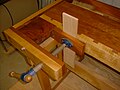 A board clamped in a shoulder vise