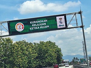 Fully graphical variable message sign reminding motorists to reduce speed during rain in North-South Expressway, Perak, Malaysia