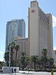 Ground-level view of a 38-story tower and a 28-story tower, both brown in color.