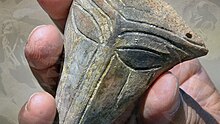 "A holding the Chalcolithic mask"