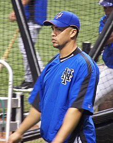 Carlos Beltrán in a warm-up jersey riding on a cart