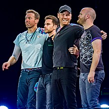 Four men in T-shirts standing.