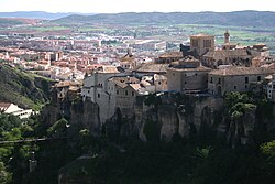 View of Los Canónigos, Casas Colgadas (in the foreground), San Pablo Bridge (bottom left) and Downtown Cuenca (background), as seen from Palomera highway