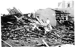 Pile of collapsed timber and assorted bricks