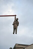 Czech sculptor David Černý (1997) depicts Sigmund Freud holding onto a horizontal beam that extends above a street from a roof. It is permanently placed in Husova Street in Prague's Old Town.