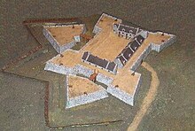 A photograph of a museum model of the fort in a glass case.