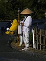 A Buddhist pilgrim begging for alms outside a Buddhist temple.