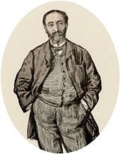 informal portrait of man in early middle age with his hands in his trouser pockets