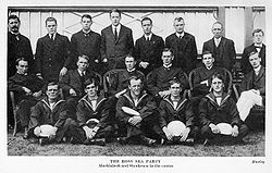 A group of 19 men arranged in three rows, many of them in naval uniforms