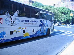 Colorfully-decorated bus at a traffic light