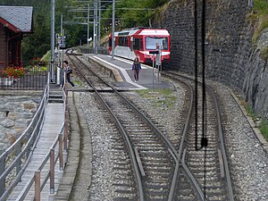 Red-and-white train at island platform