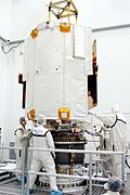 A suited worker looks over the hydrazine fuel supply to be loaded in MESSENGER.