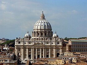 Photo. The façade is wide and has a row of huge columns rising from the basement to support the cornice. The ribbed, ovoid dome is surmounted by a lantern topped with ball and cross. Its drum is framed by two very much smaller domes.