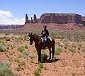 Image 24A Navajo boy in the desert in present-day Monument Valley in Arizona with the "Three Sisters" rock formation in the background in 2007 (from Indigenous peoples of the Americas)