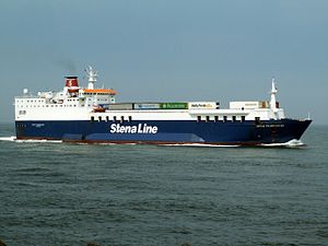 The ship 'Nordic Ferry' has an blue-coloured hull, a white superstructure and a red funnel. White lettering names the operator Stena Line. A number of lorries are visible on the deck. The ship is at sea and making headway.