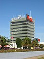 A building rooftop supporting numerous dish and sectored mobile telecommunications antennas (Doncaster, Victoria, Australia).