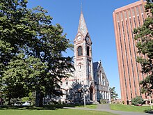 A building at UMass Amherst with the library in the background