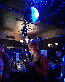 Photograph of a bar with a chandelier and disco ball