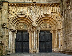 The Porta Platerias, Cathedral of Santiago de Compostela, by Master Esteban, has two wide openings with tympanums supported on brackets. The sculptured frieze above is protected by an eave on corbels.