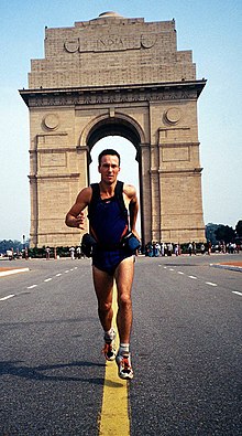 Full-length photo of Robert Garside beginning an around the world run from the monument of India Gate, New Delhi, India.