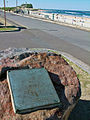 A view looking up Nobbys Beach with the History Marker Plaque in the foreground