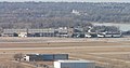 Eppley Airfield terminal in Omaha. The houses just beyond are in Carter Lake, Iowa (with Carter Lake visible to the right). The bluffs are in Omaha.