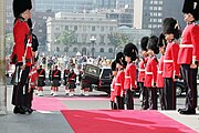 The Canadian Grenadier Guards' full dress headgear is a bearskin cap with a white plume.