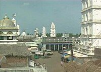 twin minarets with two minarets in the background