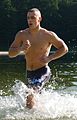 A U.S. Marine running through water