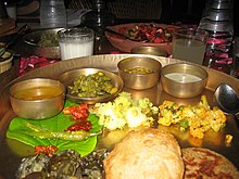 Gujarati style vegetarian thali served in a restaurant.