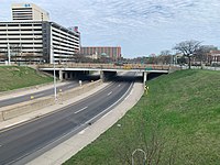 A view of Interstate highway 375, showing both carriageways of the freeway and an overpass with a sign for Larned Street.