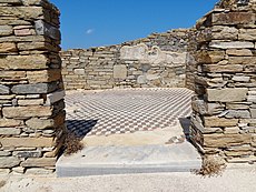 Cubic geometric-patterned floor mosaic in the ruins of a home