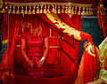 Chinese bride wearing cheongsam for wedding ceremony.