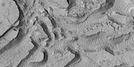 Enlarged view of a group of mesas, as seen by HiRISE under HiWish program. One surface is forming square shapes.