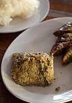 Aep ong-o, a northern Thai dish of chopped pig's brain mixed with egg and a Thai curry paste. It is wrapped in banana leaves and grilled.