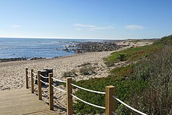 Cape Santo André, with occasional sea spray, as seen from Jardim da Praia Promenade in Póvoa de Varzim.