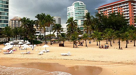 Beach chairs and people on Condado Beach