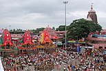 The Jagannath Puri with the three chariots of the deities with the Jagannath Temple, Puri in the background.