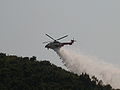 Hong Kong Government Flying Service Eurocopter Super Puma AS-332L2 putting out hillfire with a belly mounted water tank