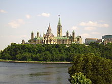 A building with a central clock tower rising from a block